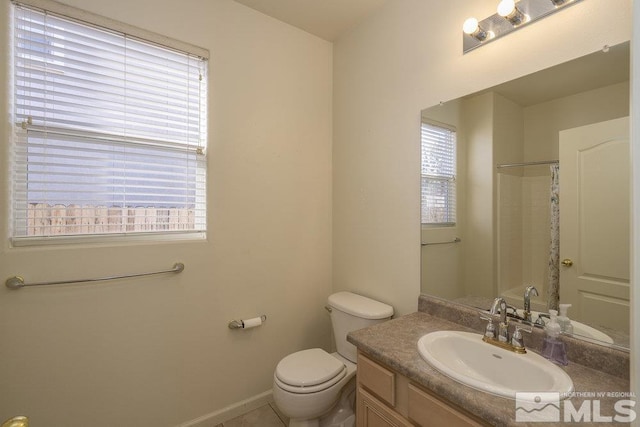 bathroom with toilet, walk in shower, and vanity