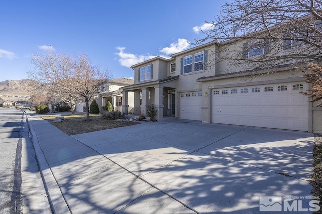 view of property with a garage and a mountain view