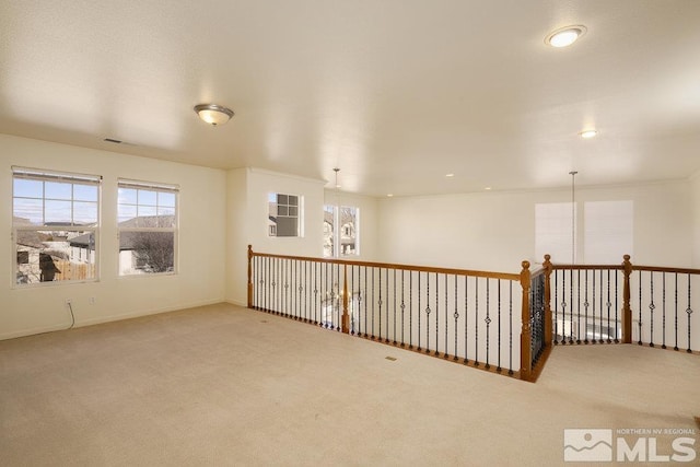 empty room with an inviting chandelier and carpet