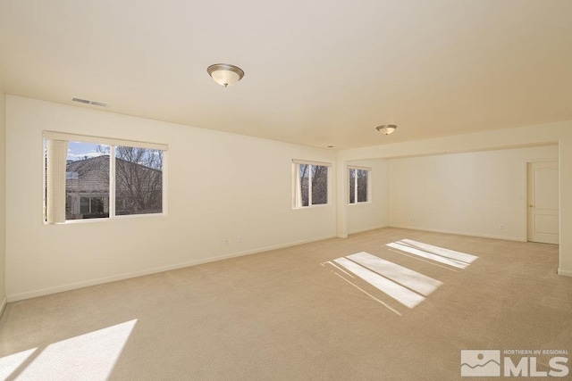 unfurnished room with light carpet