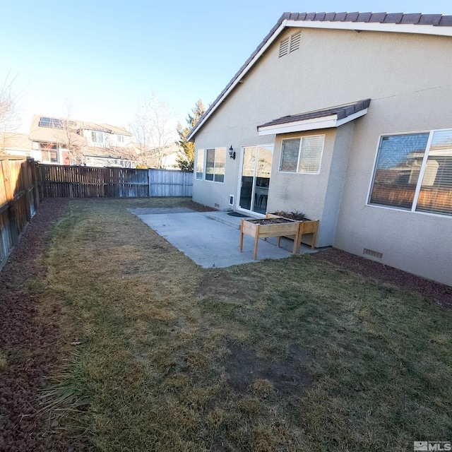 back of house featuring a patio area and a yard