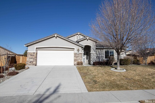 view of front of home featuring a garage and a front lawn