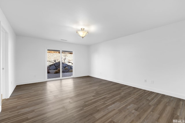 unfurnished room with dark hardwood / wood-style flooring