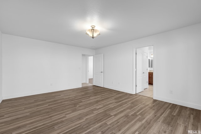 unfurnished room with wood-type flooring