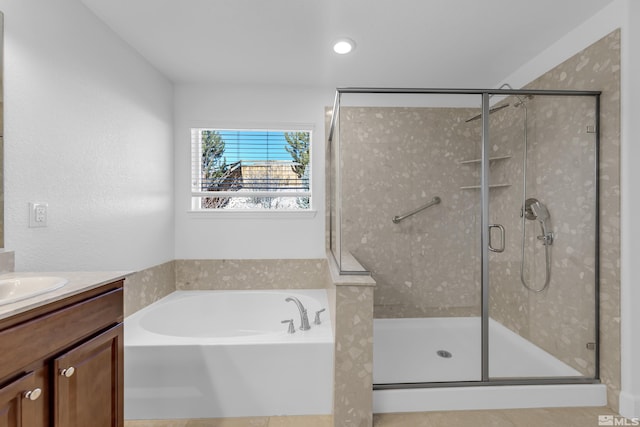 bathroom with vanity and separate shower and tub