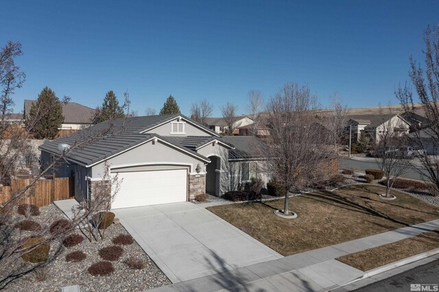 view of front of property with a front yard and a garage