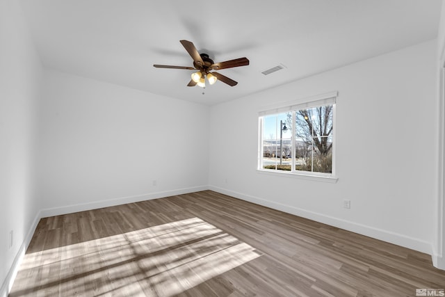 spare room featuring hardwood / wood-style floors and ceiling fan