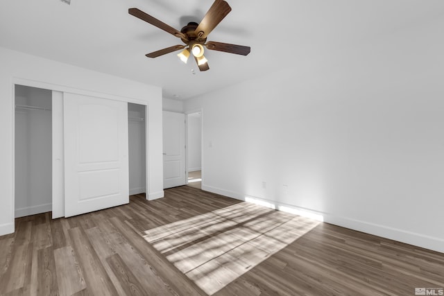 unfurnished bedroom with ceiling fan, hardwood / wood-style floors, and a closet