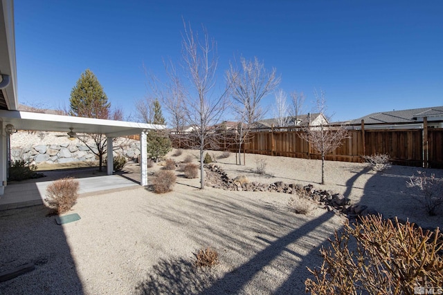 view of yard featuring a patio area and ceiling fan