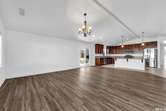 unfurnished living room with a notable chandelier, dark hardwood / wood-style flooring, and lofted ceiling with beams