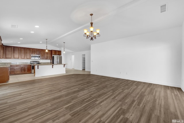 unfurnished living room with a chandelier, vaulted ceiling with beams, and light hardwood / wood-style flooring