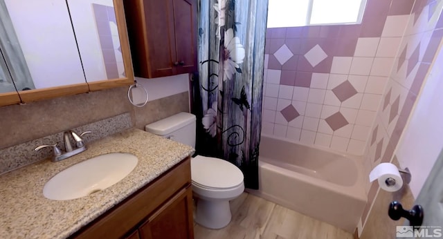 full bathroom featuring shower / tub combo with curtain, vanity, and toilet