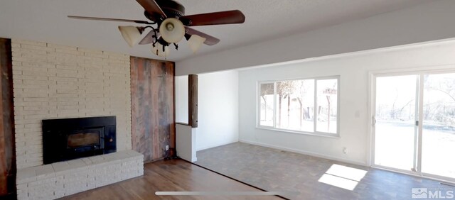 unfurnished living room featuring ceiling fan