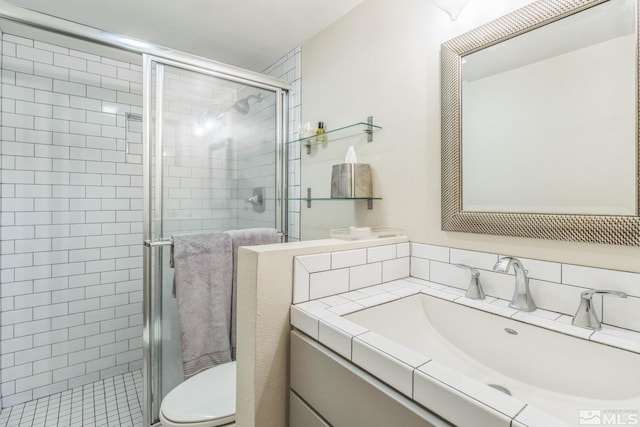 bathroom with a shower with door, vanity, and toilet