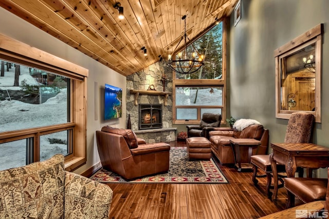 living room featuring a stone fireplace, hardwood / wood-style floors, wooden ceiling, a chandelier, and lofted ceiling