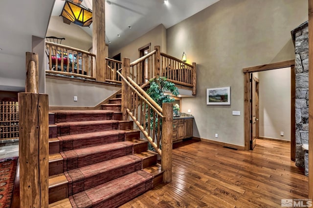 stairs with hardwood / wood-style floors