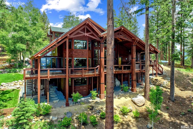 rear view of house with a wooden deck