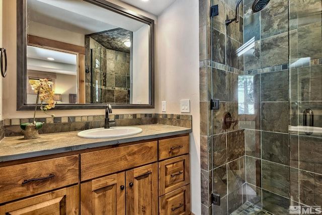 bathroom with an enclosed shower and vanity