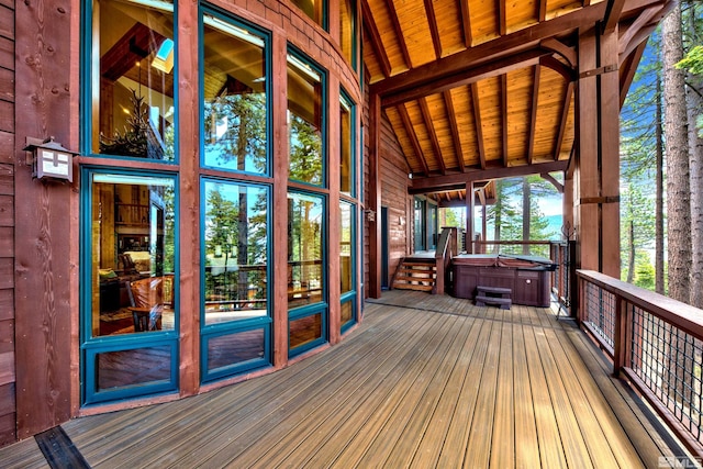 wooden terrace featuring a hot tub