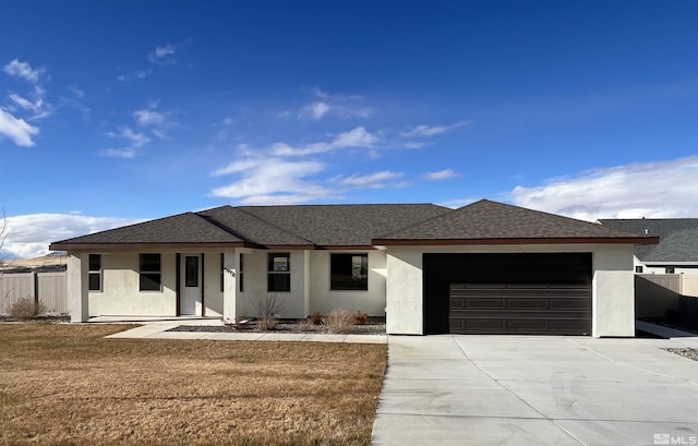 view of front of property featuring a front lawn and a garage