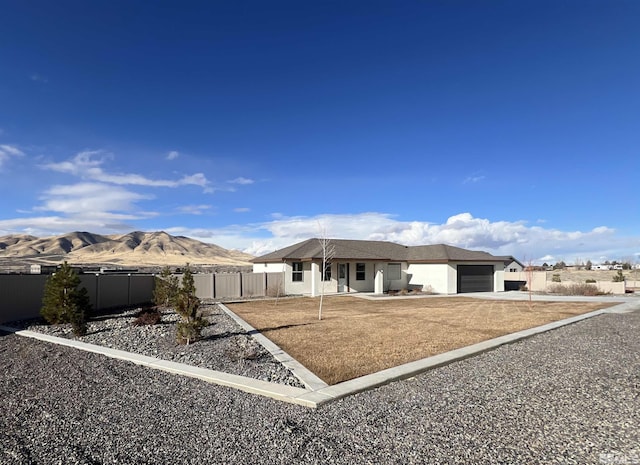 view of front of house with a garage and a mountain view