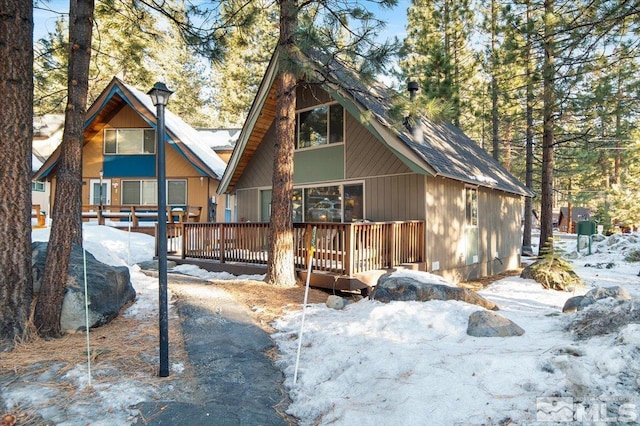 snow covered property featuring a deck