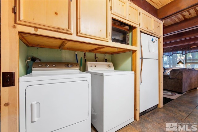 clothes washing area featuring washer and dryer