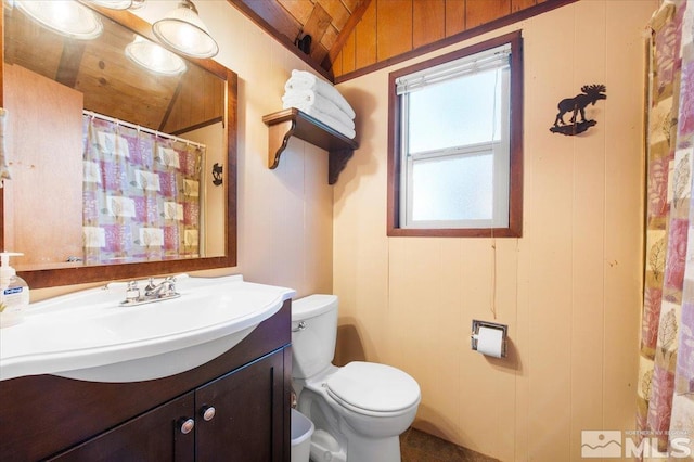 bathroom with wooden ceiling, lofted ceiling, vanity, and toilet