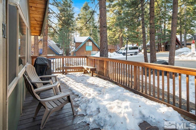 snow covered deck featuring area for grilling