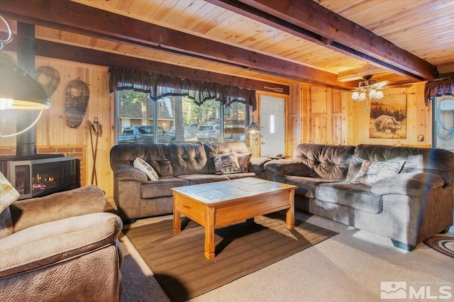 carpeted living room featuring wood walls, ceiling fan, wood ceiling, and beam ceiling