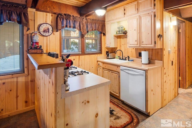 kitchen with sink, wooden walls, white appliances, and light brown cabinets