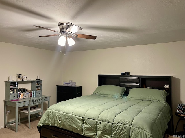 carpeted bedroom with ceiling fan and a textured ceiling