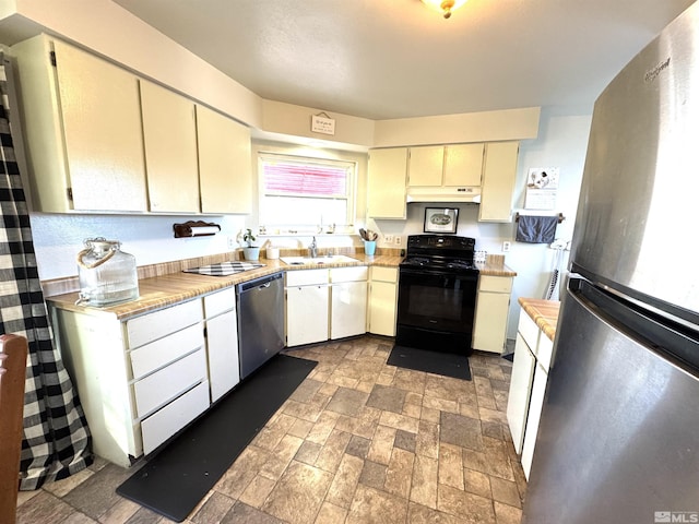 kitchen featuring sink, cream cabinets, and appliances with stainless steel finishes