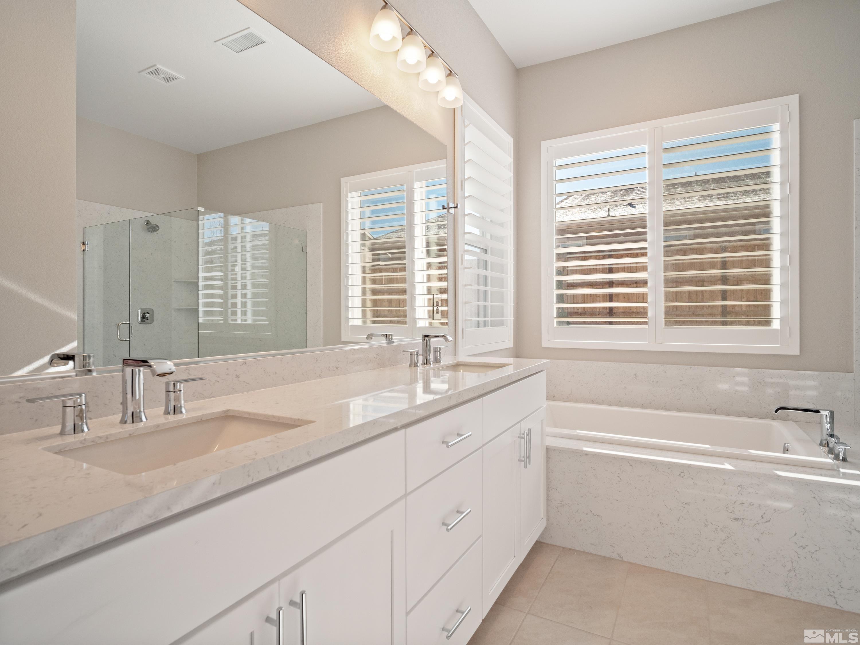 bathroom with vanity, tile patterned floors, and independent shower and bath