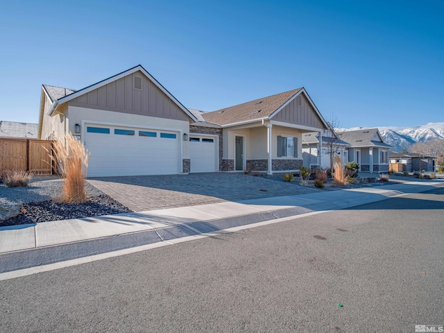 view of front facade featuring a garage and a mountain view