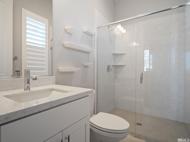 bathroom with toilet, an enclosed shower, and vanity