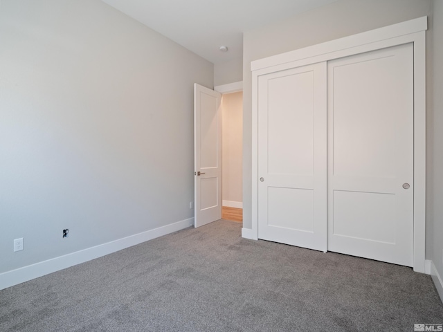 unfurnished bedroom featuring a closet and carpet