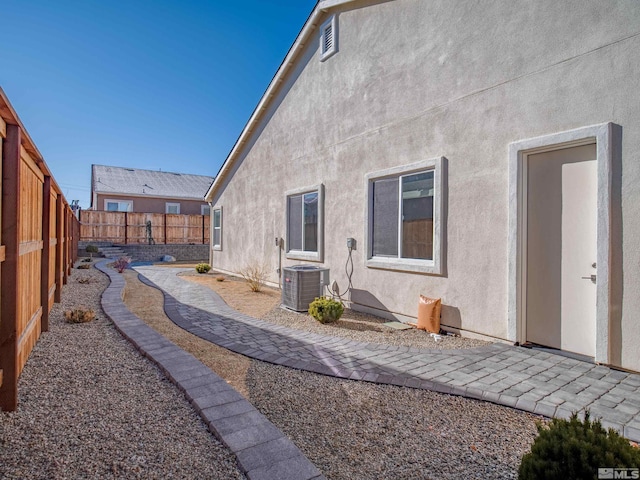 rear view of property featuring central AC unit