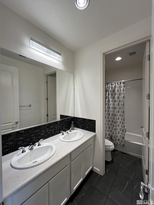 full bathroom featuring toilet, vanity, decorative backsplash, shower / bath combo, and a textured ceiling