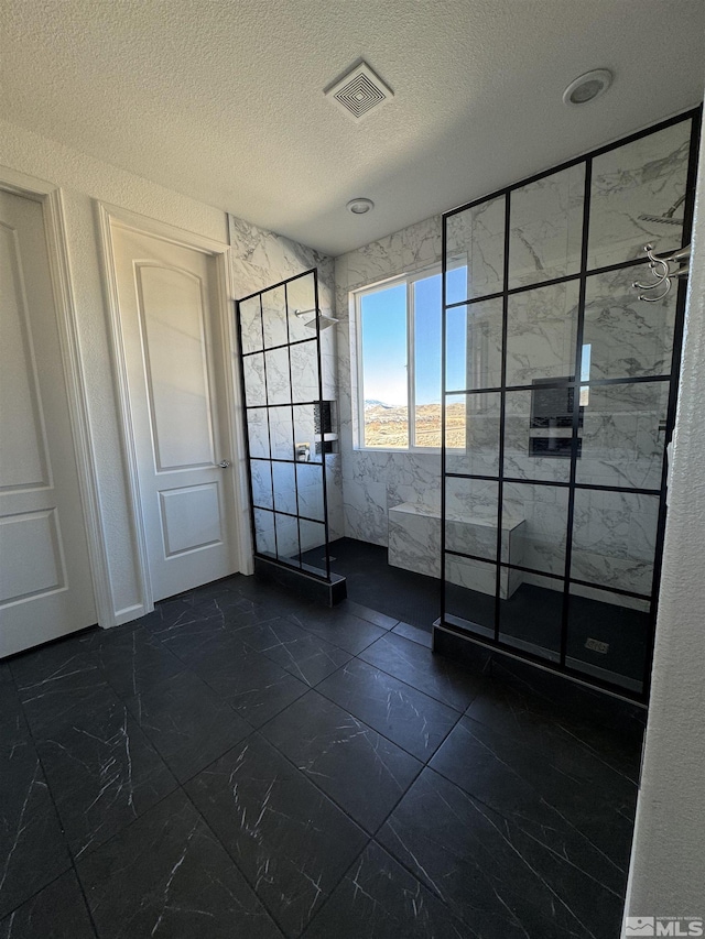 unfurnished room featuring a textured ceiling