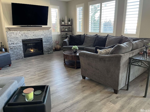 living area with light wood-type flooring and a fireplace