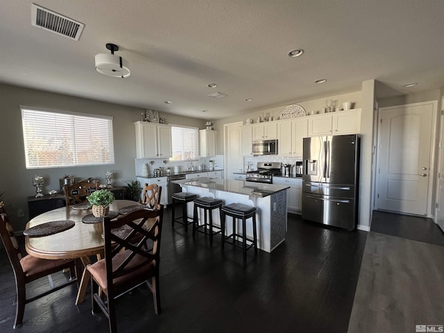 dining space with dark wood-type flooring and sink