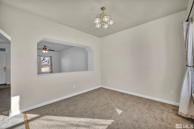 empty room with carpet and ceiling fan with notable chandelier