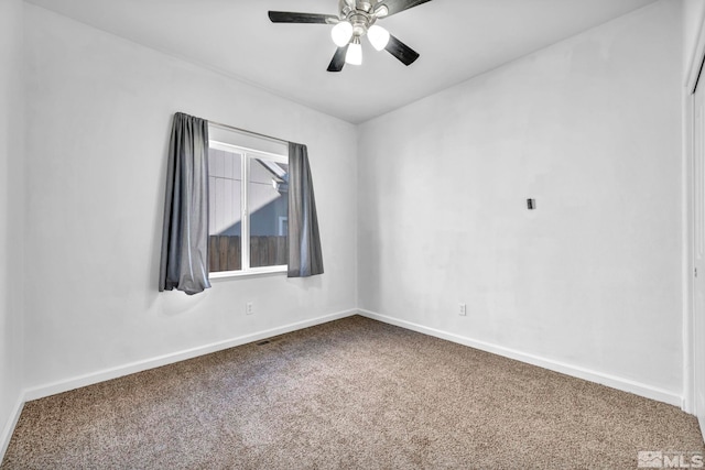 carpeted spare room with ceiling fan