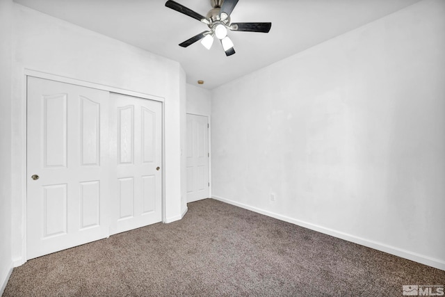 unfurnished bedroom with a closet, ceiling fan, and dark colored carpet