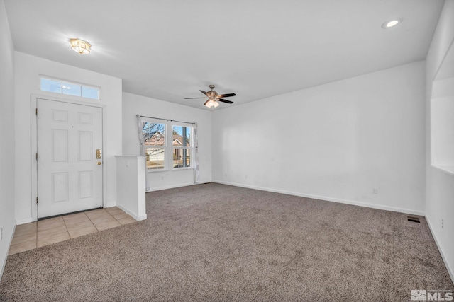 foyer entrance featuring ceiling fan and light colored carpet