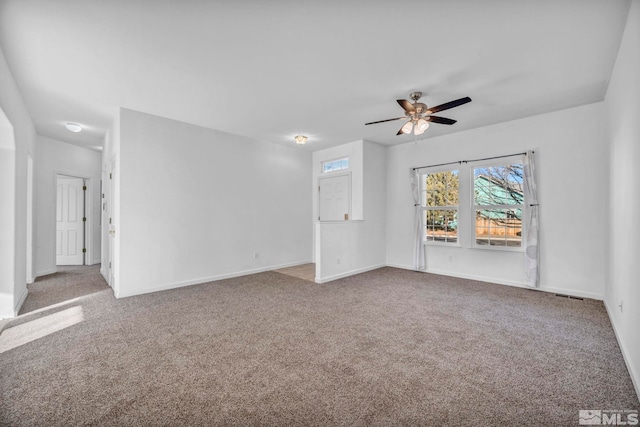 empty room featuring carpet flooring and ceiling fan