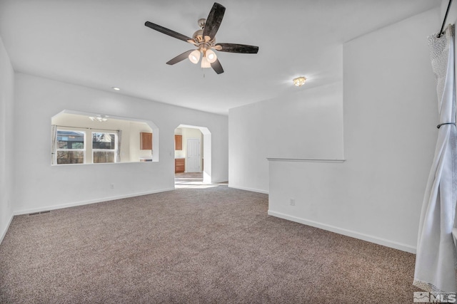 unfurnished living room featuring ceiling fan and carpet