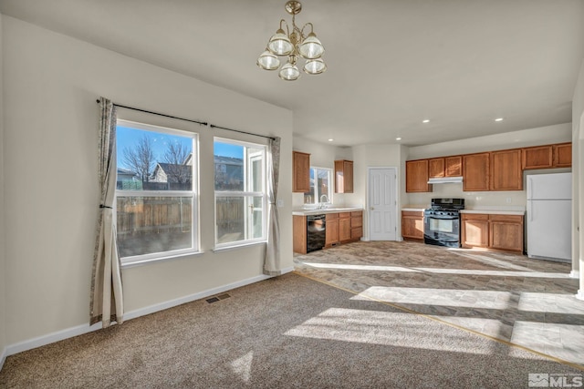 kitchen with sink, decorative light fixtures, black appliances, and a notable chandelier