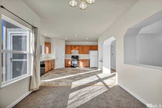 kitchen with dishwasher, range, white fridge, and light colored carpet